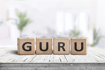 Image showing Guru sign on a wooden table in a bright room