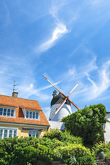 Image showing Idyllic mill in a small town under a blue sky
