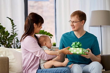 Image showing mother with baby giving birthday present to father