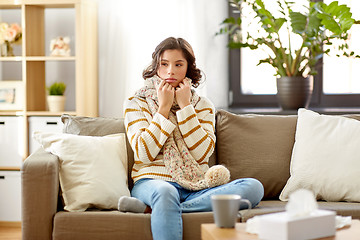 Image showing sad sick woman in scarf at home