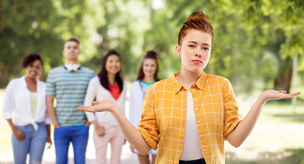 Image showing sad red haired teenage girl shrugging