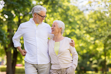 Image showing happy senior couple hugging at summer park