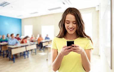 Image showing teenage student girl using smartphone at school