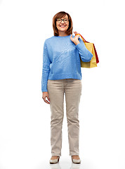 Image showing senior woman with shopping bags isolated on white