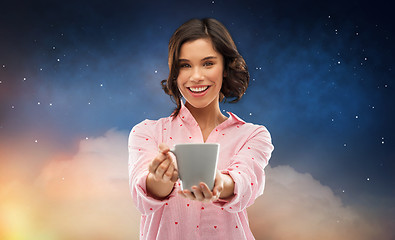 Image showing happy young woman in pajama with mug of coffee