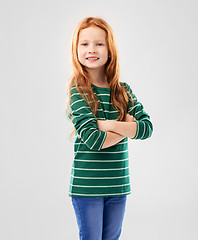 Image showing smiling red haired girl posing with crossed arms