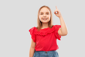 Image showing smiling girl in red shirt pointing finger up