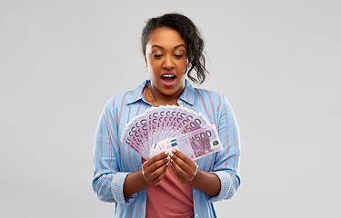 Image showing surprised african american woman with euro money