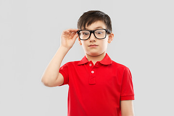 Image showing astonished boy in glasses and red t-shirt goggling