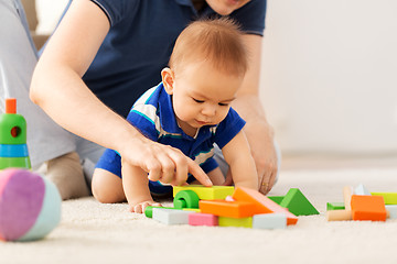 Image showing baby boy with father playing toy blocks at home