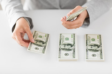 Image showing close up of woman hands counting us dollar money