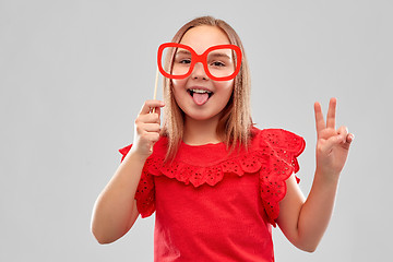 Image showing smiling girl with big paper glasses showing peace