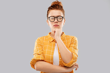 Image showing thinking redhead teenage student girl in glasses