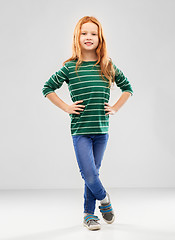 Image showing smiling red haired girl posing in striped shirt