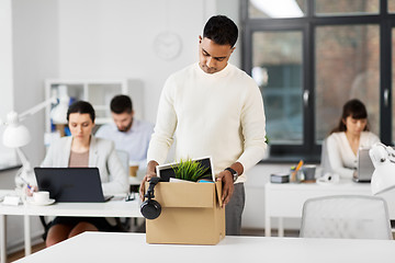 Image showing sad fired male office worker with personal stuff