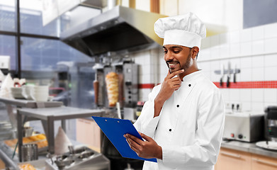 Image showing indian chef with menu on clipboard at kebab shop