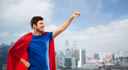 Image showing man in red superhero cape over singapore city