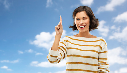 Image showing happy woman showing one finger or pointing up