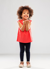 Image showing happy african american girl holding something