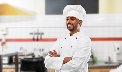 Image showing happy indian chef in toque at restaurant kitchen