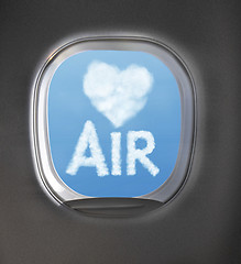 Image showing Airplaine window with heart symbol and word air from clouds.