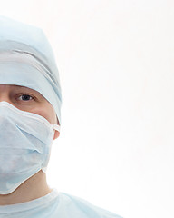 Image showing Half face portrait of surgeon in sterile surgical mask and medical cap