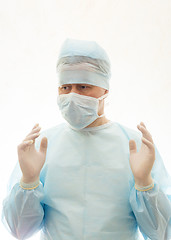 Image showing Right positioned hands of ready to work surgeon in sterile gown, mask and gloves