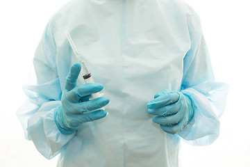 Image showing A surgeon in sterile clothing with a syringe is ready to make an injection