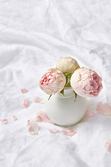 Image showing Ceramic vase with roses on a sheet.