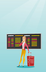 Image showing Woman looking at departure board at the airport.