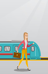 Image showing Young woman walking on a railway station platform.