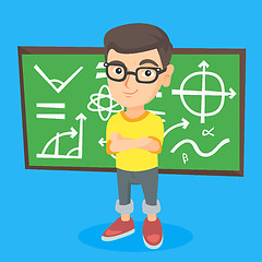 Image showing Little schoolboy standing in front of blackboard.