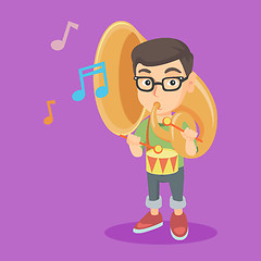 Image showing Caucasian kid playing the tuba and the drum.
