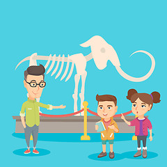 Image showing Kids with a teacher studying a skeleton in museum.