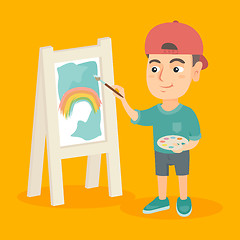 Image showing Caucasian boy artist painting picture on a canvas.