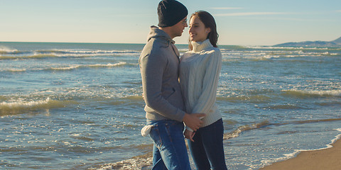 Image showing Couple having fun on beautiful autumn day at beach