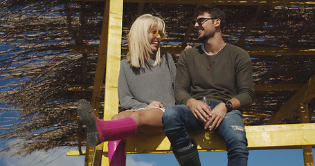 Image showing Couple drinking beer together at the beach