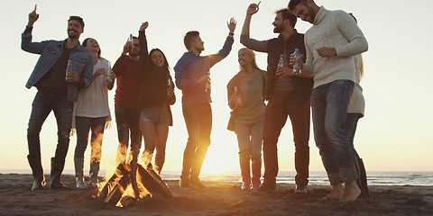 Image showing Friends having fun at beach on autumn day