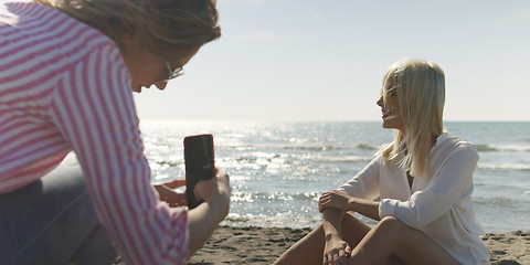 Image showing Two girl friends having fun photographing each other on vecation