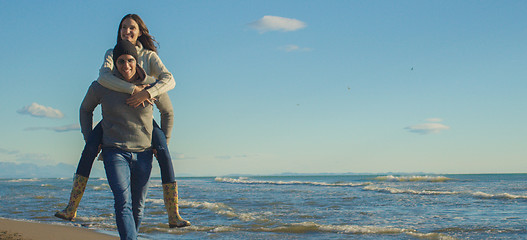 Image showing couple having fun at beach during autumn