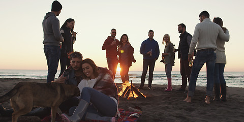 Image showing Friends having fun at beach on autumn day