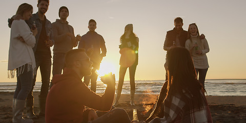 Image showing Friends having fun at beach on autumn day