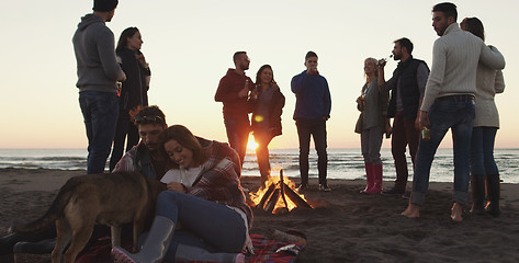 Image showing Friends having fun at beach on autumn day