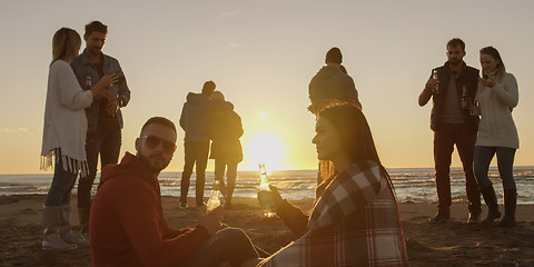 Image showing Friends having fun at beach on autumn day