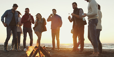 Image showing Friends having fun at beach on autumn day