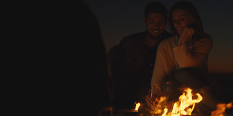 Image showing Couple enjoying with friends at night on the beach