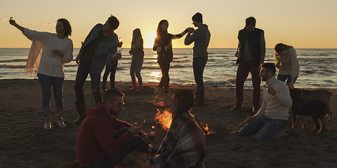 Image showing Friends having fun at beach on autumn day