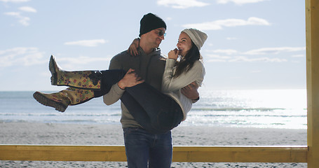 Image showing Couple having fun on beautiful autumn day at beach