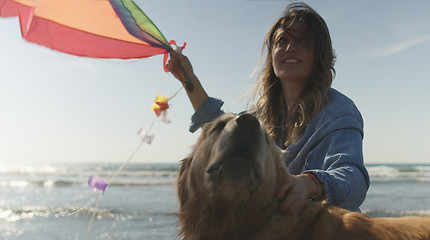 Image showing Woman holding kite at beach on autumn day