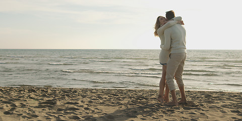 Image showing Loving young couple on a beach at autumn on sunny day